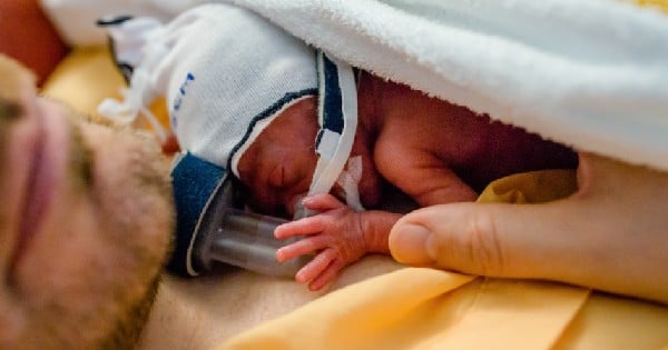 premature baby on father's chest