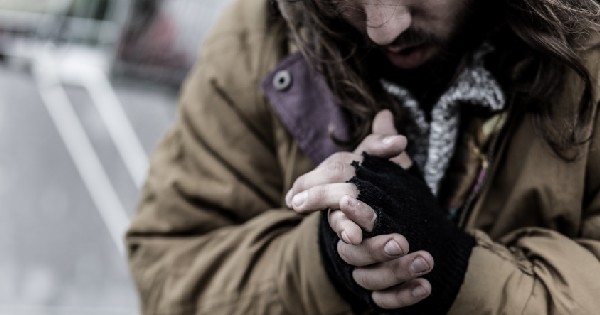 homeless man with folded hands