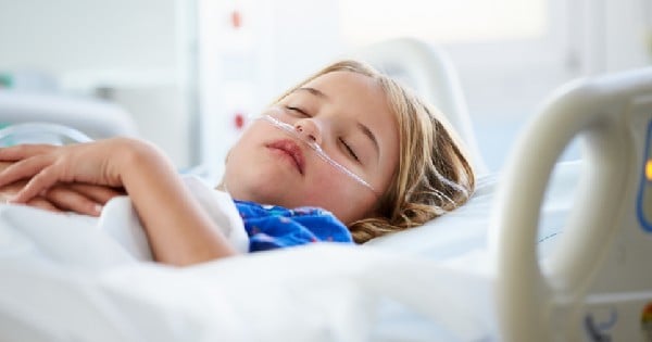 little girl asleep in hospital bed