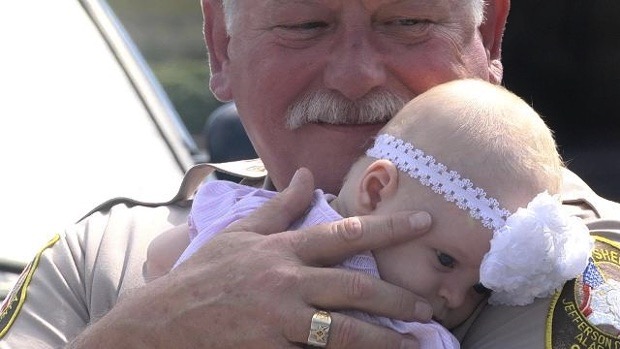 mj-godupdates-cop-holds-baby-girl-after-accident-4