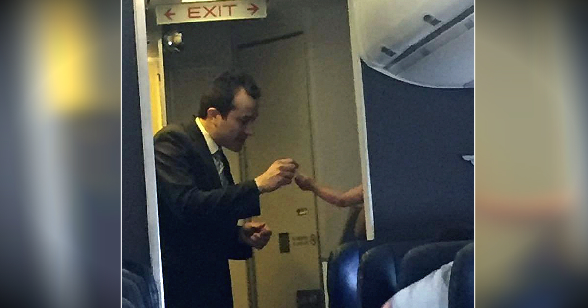 godupdates flight attendant escorted mom and crying baby to back of plane fb