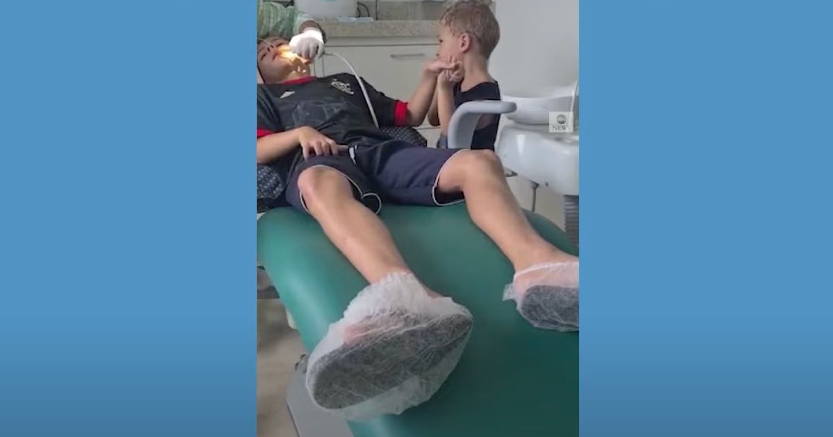 brothers holding hands at dentist