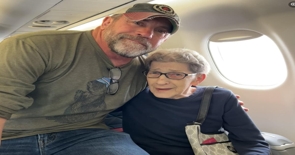 man shows kindness to elderly woman on plane